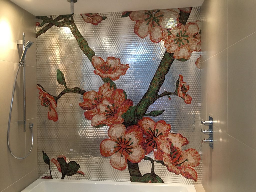 Hand-cut cherry blossom mosaic mural above bath