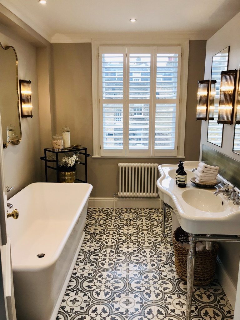 Patterned Victorian tile floor with freestanding bath