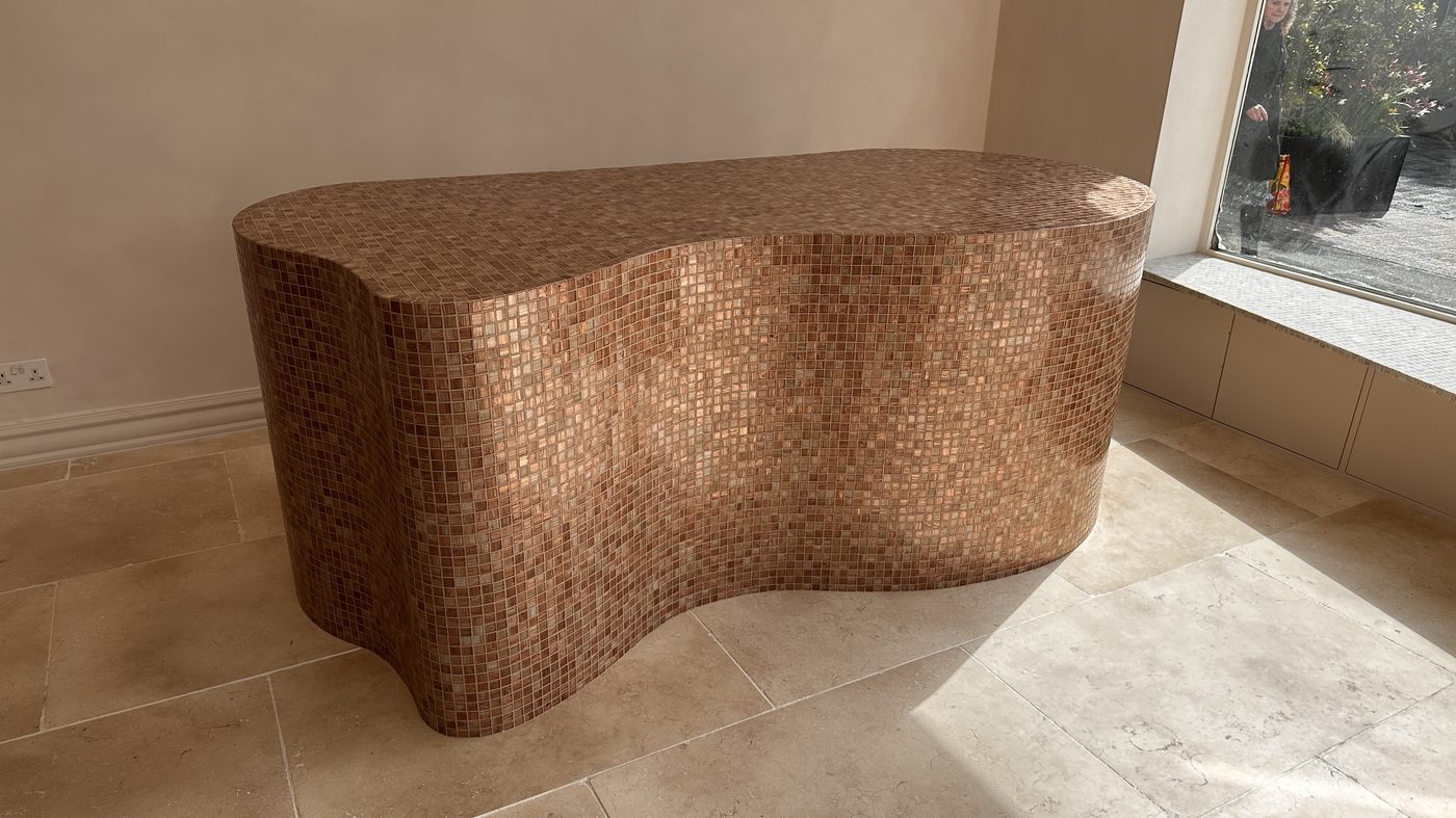 Sculptural curved console clad in copper glass mosaic