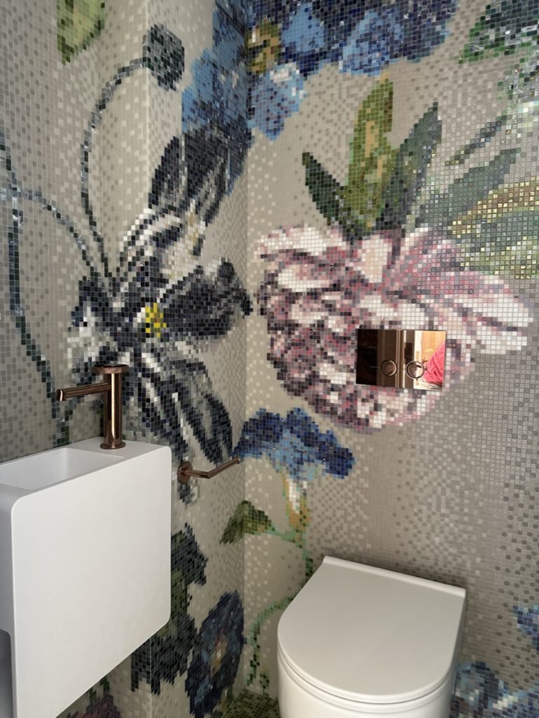 Hand-cut floral glass mosaic cloakroom feature wall