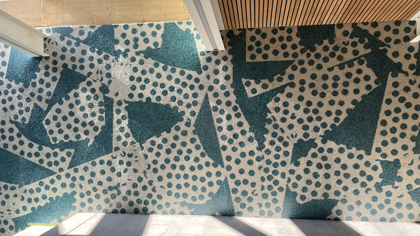 Large-scale teal and white abstract dot pattern mosaic wall