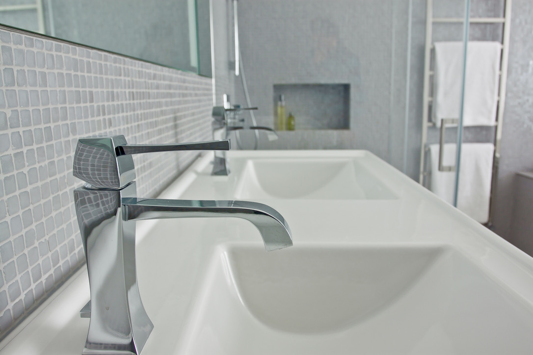 Silver mosaic double sink bathroom with wall-mounted taps