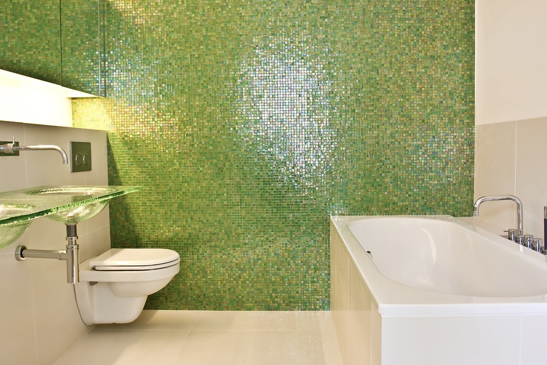 Green iridescent mosaic bathroom with bath and glass basin